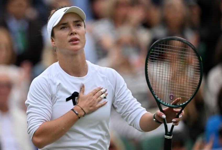 Tearful day: Elina Svitolina wears a black ribbon in her win over China's Wang Xinyu