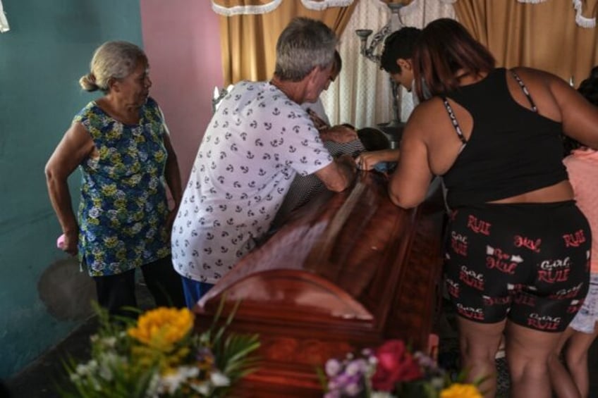 Relatives of Victor Alfonzo Bustos, 35, during his wake in Valencia, Venezuela, on July 31