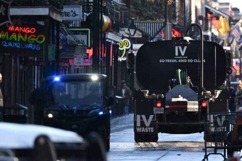 A truck cleans Bourbon Street in the French Quarter of New Orleans, Louisiana on January 2