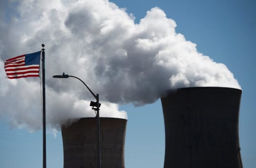 Steam rises out of the nuclear plant on Three Mile Island, with the operational plant run