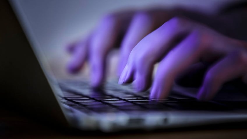 hands typing on a keyboard