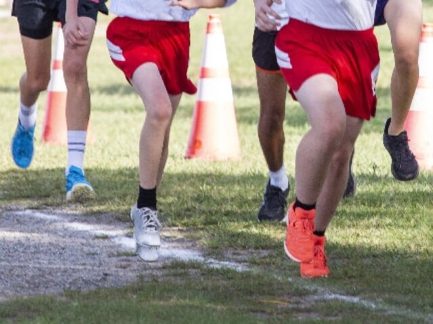 High school cross country runners racing to the finsih line