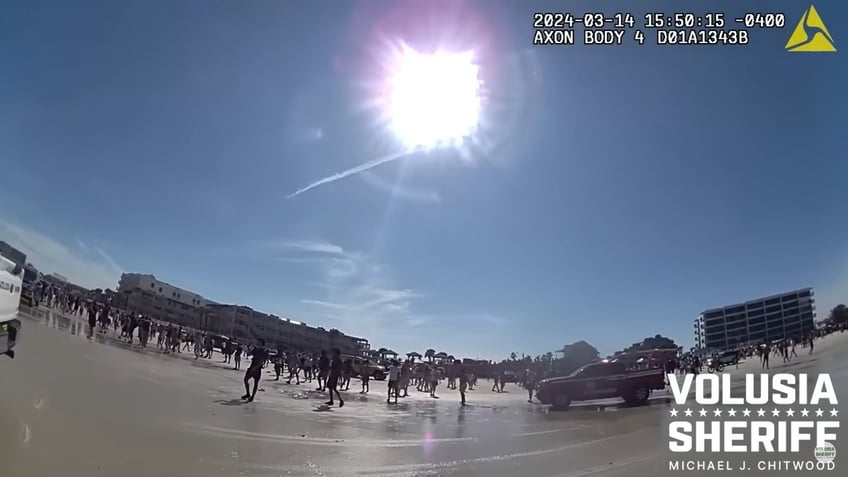 The beach was crowded when the suspect brandished the gun. Officers constantly yelled to clear the beach and forced the bystanders back as they arrested the suspect.