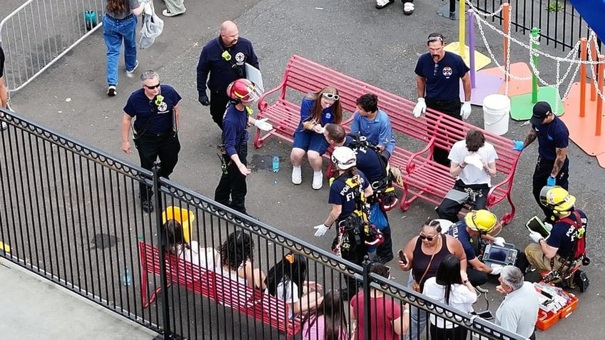 Medical personnel examine a theme park rider