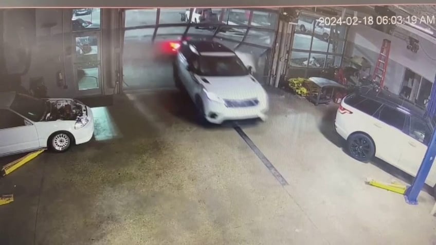 car driving through dealership door