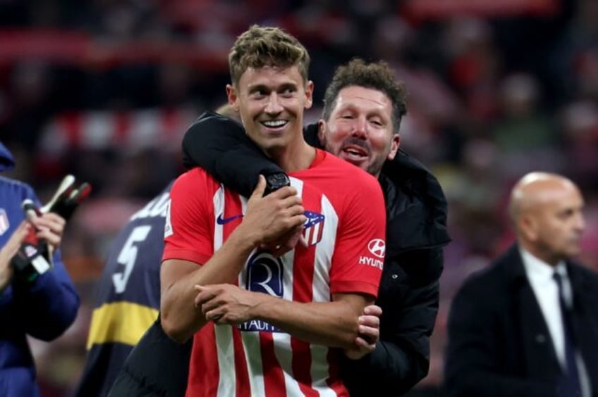 Atletico Madrid coach Diego Simeone hugs his match winner Marcos Llorente