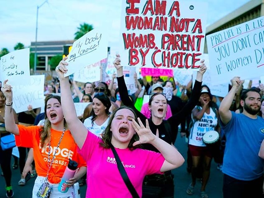 Protesters join thousands marching around the Arizona Capitol in Phoenix, protesting the U