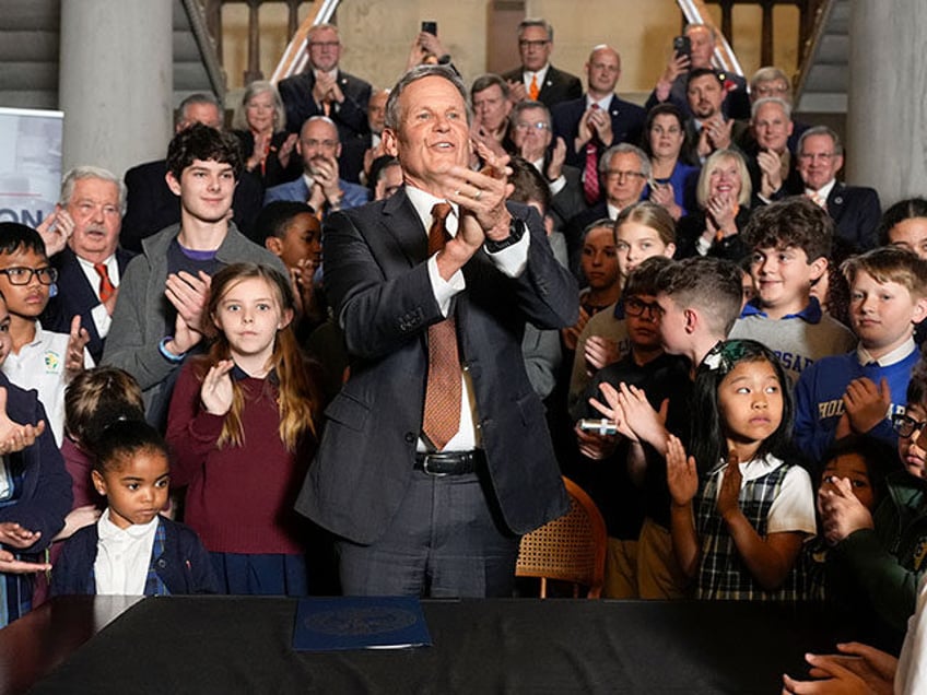 Gov. Bill Lee applauds after signing the Education Freedom Act at the state Capitol, Wedne