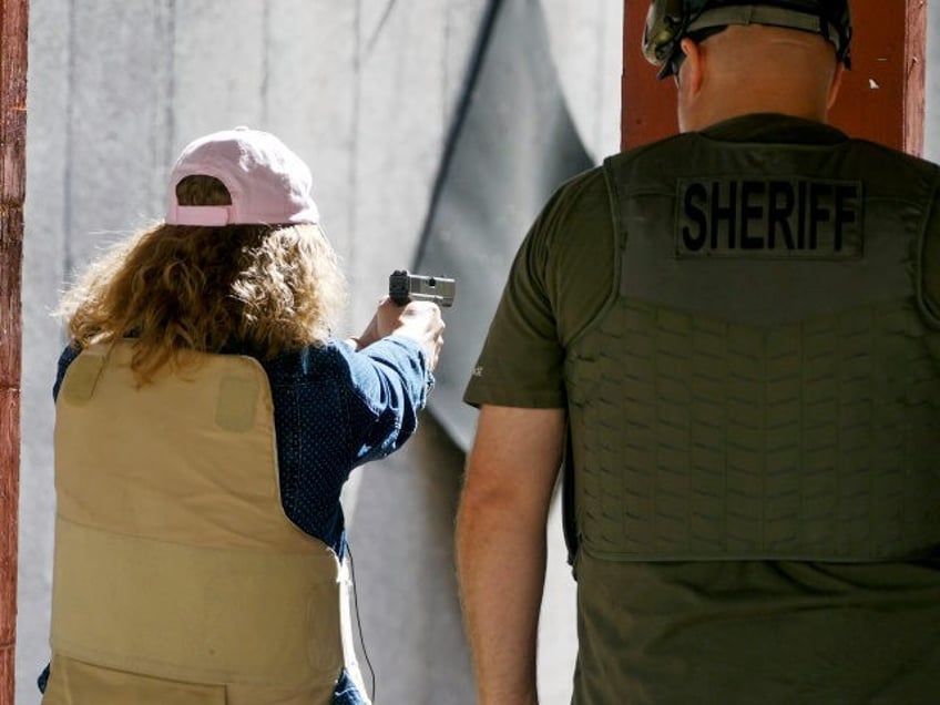 In this Saturday, June 29, 2019, photo, Cindy Bullock, Timpanogos Academy secretary, parti