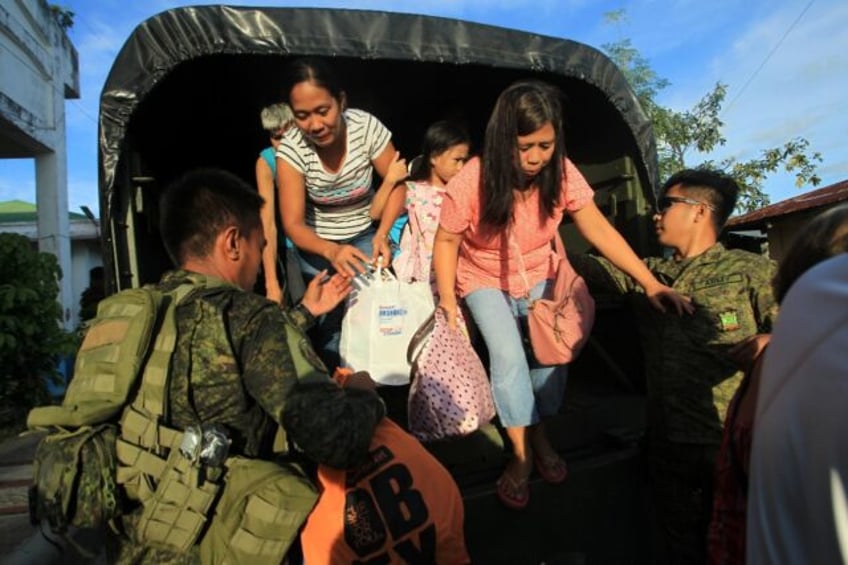 The military helped evacuate villagers from areas threatened by Typhoon Man-Yi