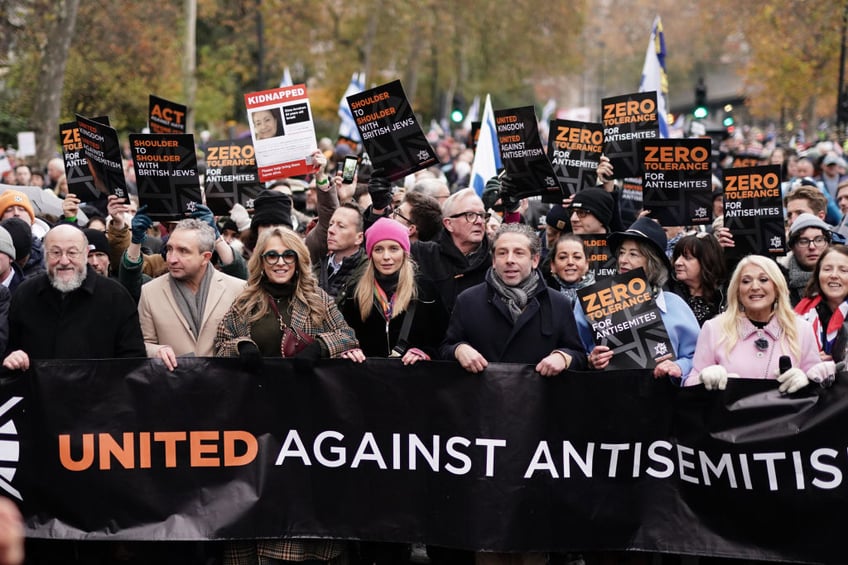 tens of thousands march against antisemitism in london including ex pm boris johnson