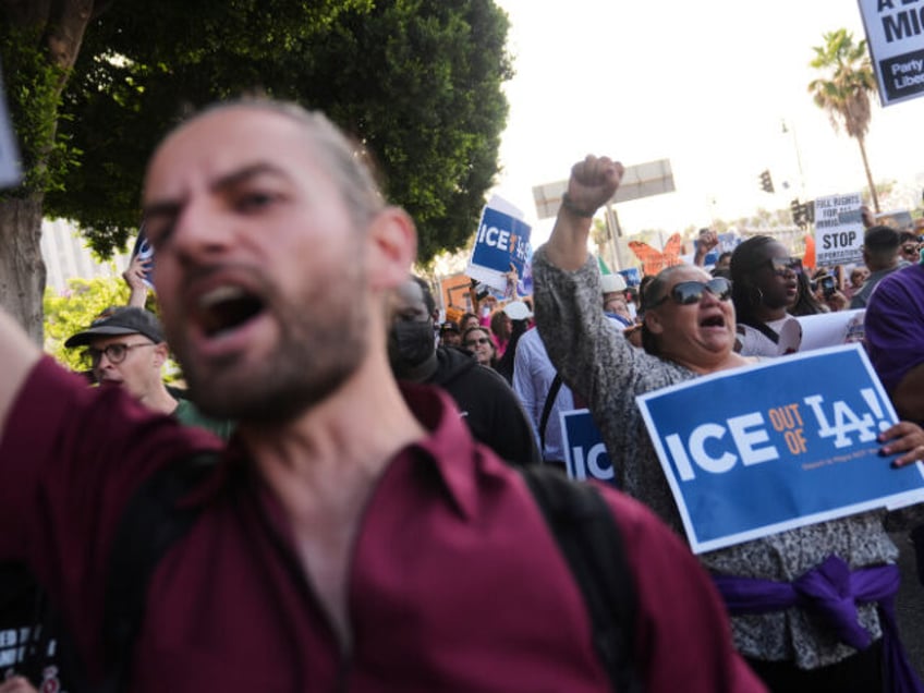 Protesters march after federal immigration authorities conducted an operation on Friday, J