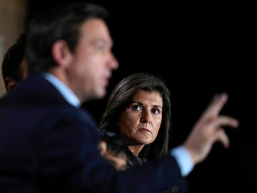 Republican presidential candidate former U.N. Ambassador Nikki Haley listens to Republican presidential candidate Florida Gov. Ron DeSantis, left, speak during the Family Leader's Thanksgiving Family Forum, Friday, Nov. 17, 2023, in Des Moines, Iowa. (AP Photo/Charlie Neibergall)