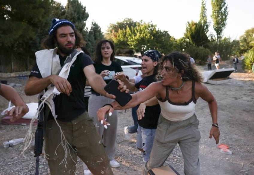 Activists confront a settler (left) near the occupied West Bank village of Beit Jala