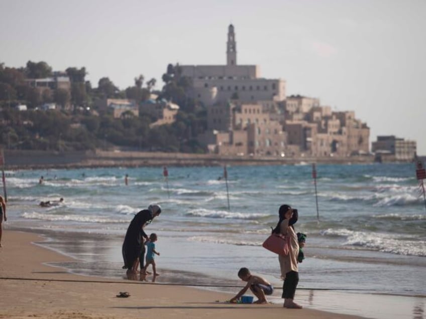 Israeli Arabs enjoy the Mediterranean Sea during the Muslim Eid al-Fitr holiday, that mark