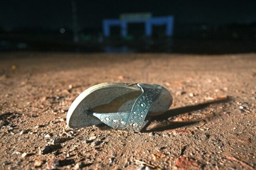 An empty sandal bears witness to a stampede that killed at least 116 people during a Hindu
