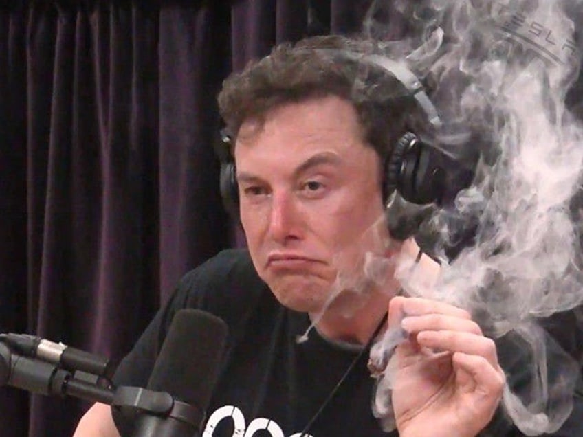 Elon Musk, Tesla chairman, smokes a "spliff" (marijuana and tobacco cigar) on the Joe Roga