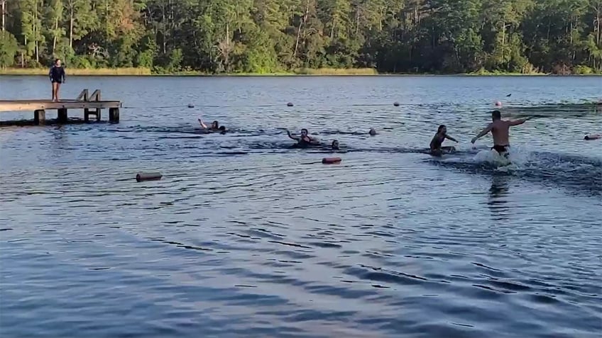 texas alligator sets sights on children swimming in lake video shows