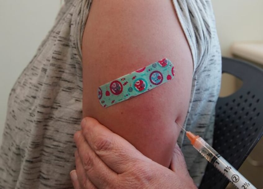 A nurse gives Michaella a measles, mumps and rubella virus vaccine made by Merck at the Ut