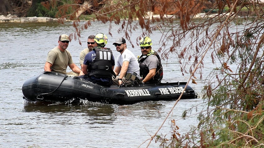 search team traveling down river in small boat