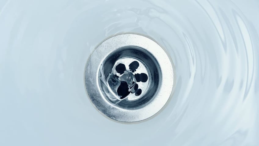 Water flows down shower drain