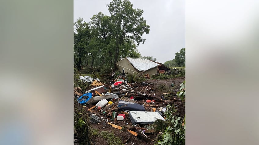 A ruined building is seen behind a pile of wreckage following extreme flooding in Texas.