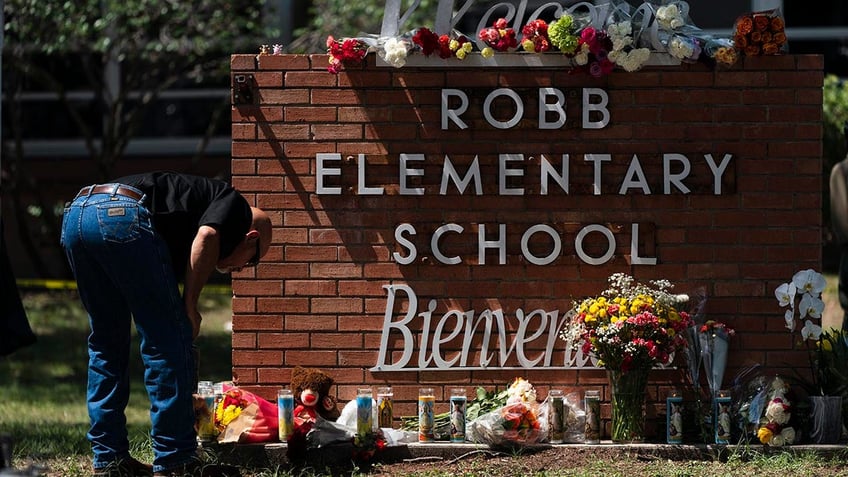 Uvalde, Texas school shooting police officer lights candle