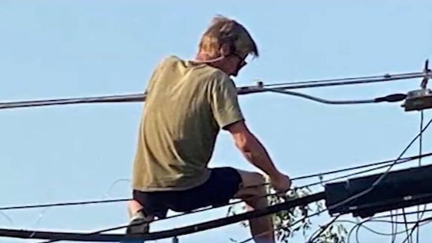 Man on power lines