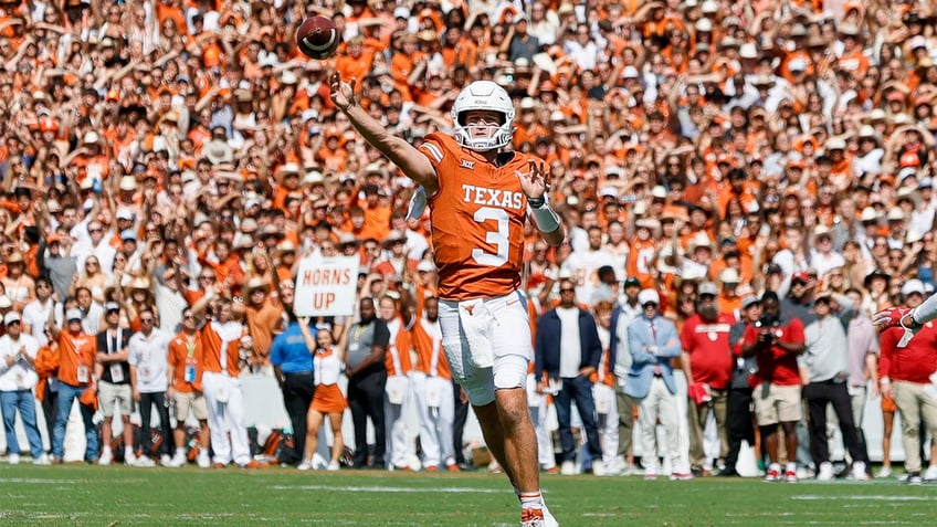 Quinn Ewers throws a pass