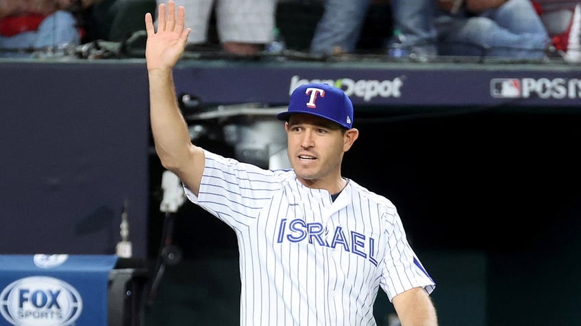 texas rangers legend ian kinsler wears team israel jersey during ceremonial first pitch in alcs