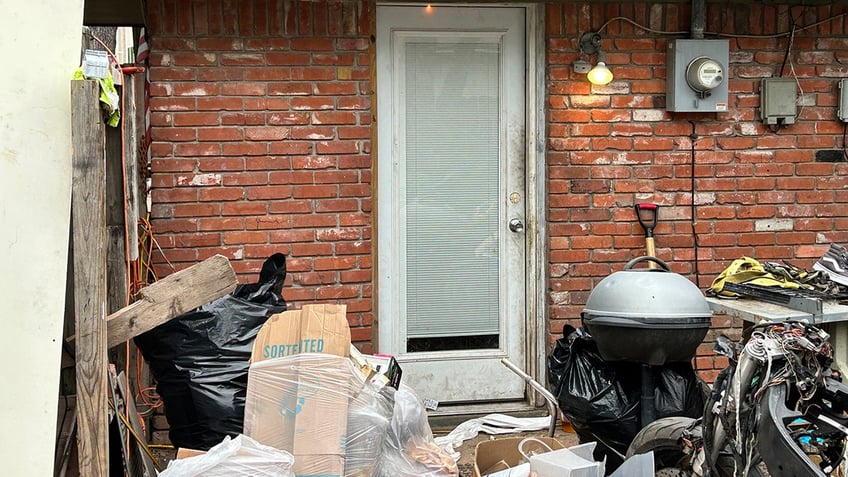 Trash in front of home when occupied by squatters