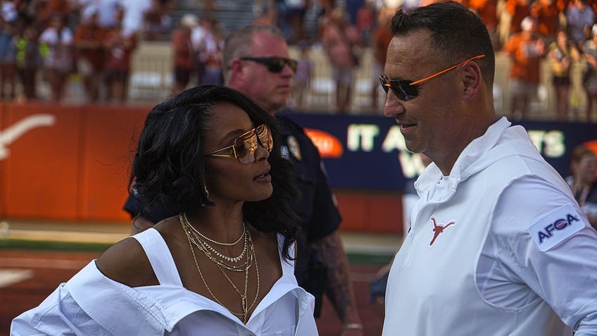 Steve Sarkisian speaks with his wife Loreal Sarkisian