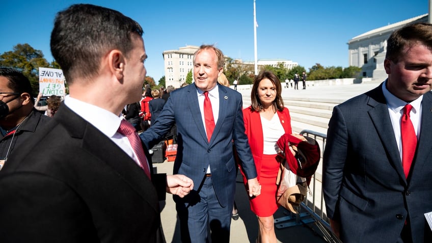 Texas Attorney General Ken Paxton and his wife Angela are pictured outside the Supreme Court on Nov. 1, 2021.