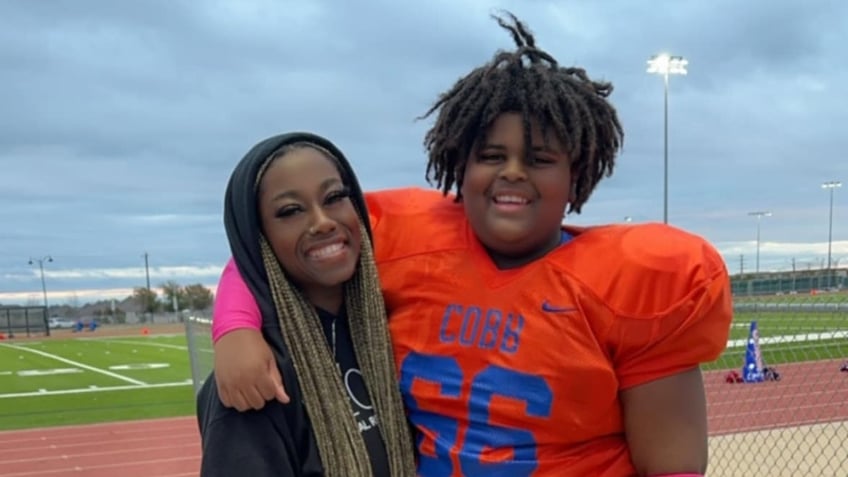 SJ Williams in a football uniform and his mother 