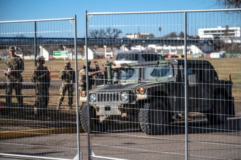 Texas National Guard members stand behind a fence at Shelby Park on February 3, 2024 in Ea