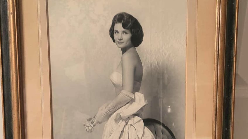 Harriet holding a rose in bridal portrait