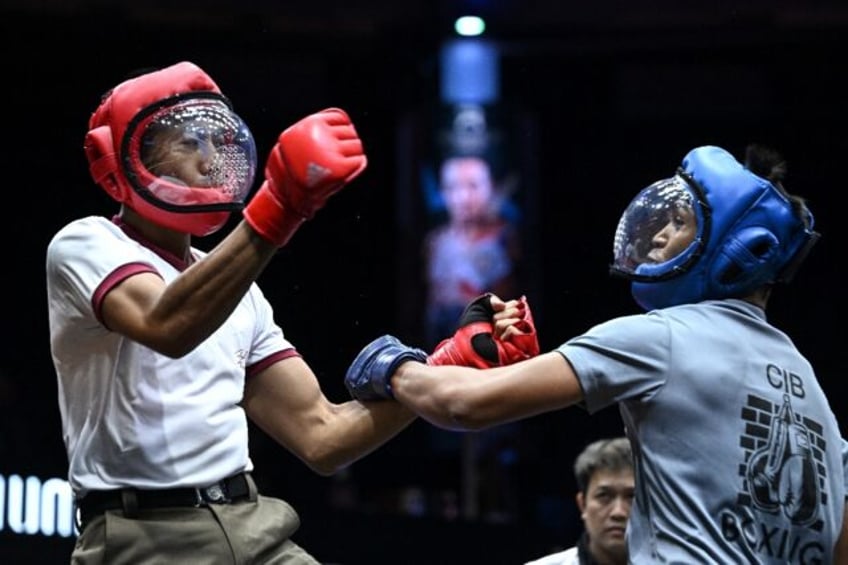 Thai police officers take part in the "Cops Combat" martial arts tournament for members of