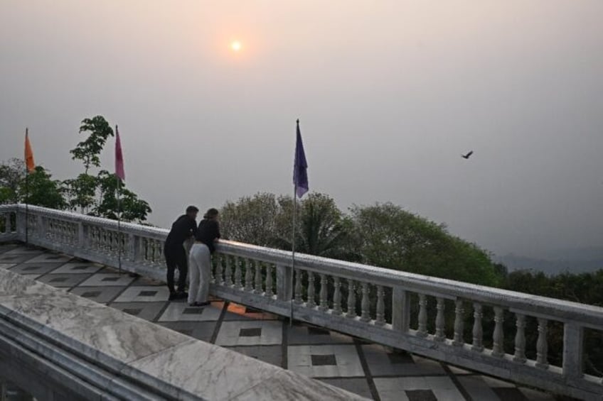Thai tourist hotspot Chiang Mai was blanketed by hazy smog Friday, as residents and visito