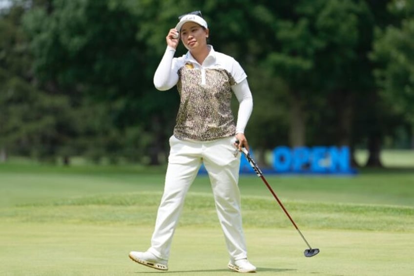 Thailand's Chanettee Wannasaen tips her cap to the crowd on her way to victory in the LPGA