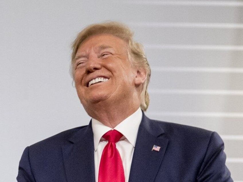 U.S. President Donald Trump and German Chancellor Angela Merkel laugh during a bilateral m