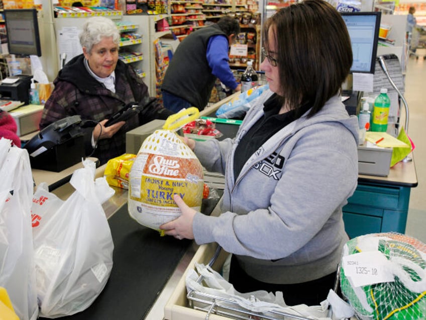 A clerk bags a turkey for a customer at Pixley's Shurfine grocery store in Akron, N.Y