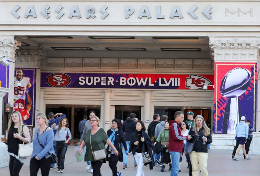 Visitors walk in front of an entrance to Caesars Palace with Super Bowl LVIII signage displayed on February 03, 2024 in Las Vegas, Nevada. The game...