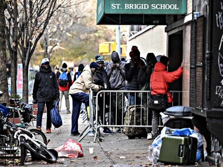 NEW YORK CITY, UNITED STATES - DECEMBER 4: Asylum seekers line up in front of the East Village re-intake, converted into a city-run shelter for newly arrived migrant families in New York City, United States on December 4, 2023. (Photo by Fatih Aktas/Anadolu via Getty Images)