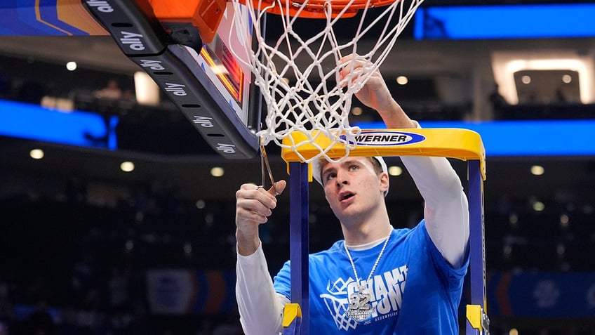 Cooper Flagg cuts down net