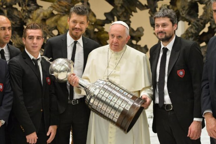 Francis holding the Libertadores Cup with members of Argentia's San Lorenzo football team