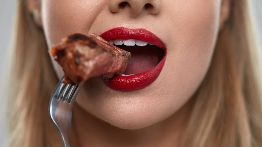 Woman eating steak