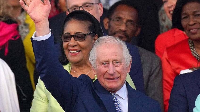 Britain's King Charles III waves as he arrives to attend the Coronation Concert at Windsor Castle