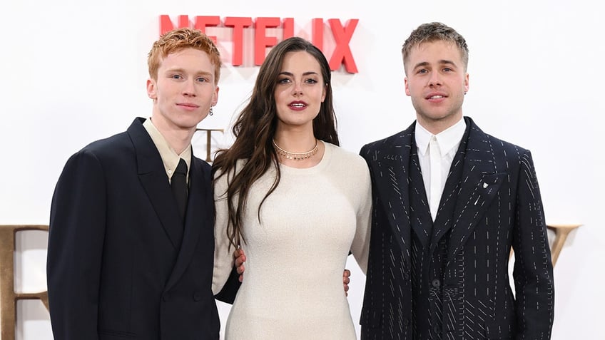 The cast of The Crown posing for a photo on the red carpet