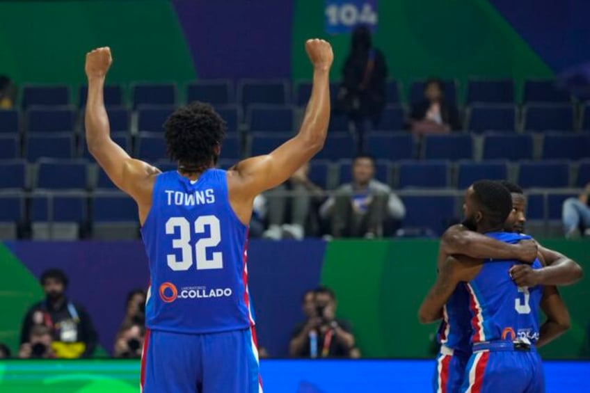 the dominican republic tops its world cup group and advances with a 75 67 victory over angola