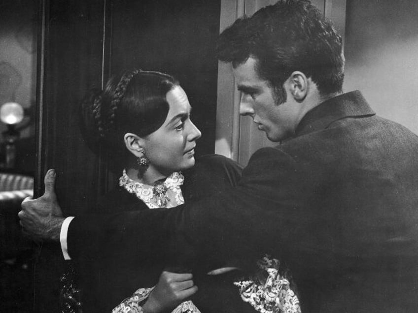 1949: American actor Montgomery Clift (1920 - 1966) blocks the path of Olivia de Havilland